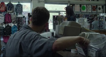 Movie still from “600 Miles” (2015), directed by Gabriel Ripstein – A man sitting at a counter with a glass of beer; Medium shot, Over the shoulder angle