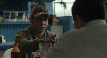 Movie still from “600 Miles” (2015), directed by Gabriel Ripstein – Two men sitting at a table talking to each other; Close Up shot, Over the shoulder angle