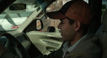 Movie still from “600 Miles” (2015), directed by Gabriel Ripstein – A man in a baseball cap sitting in the driver's seat of a car; Close Up shot, High angle