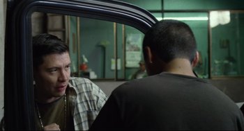 Movie still from “600 Miles” (2015), directed by Gabriel Ripstein – Two men are sitting in a car and one of them is talking to another man; Close Up shot, Over the shoulder angle