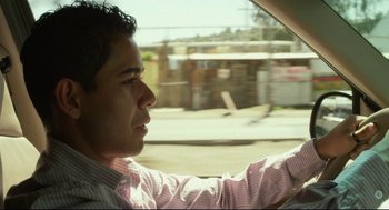Movie still from “600 Miles” (2015), directed by Gabriel Ripstein – A man driving a car on the street; Close Up shot, Over the shoulder angle