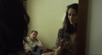 Movie still from “600 Miles” (2015), directed by Gabriel Ripstein – A man and a woman looking at a cell phone; Medium shot, Over the shoulder angle