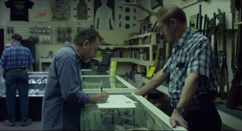 Movie still from “600 Miles” (2015), directed by Gabriel Ripstein – Two men standing at a counter in a gun shop; Medium shot, Over the shoulder angle