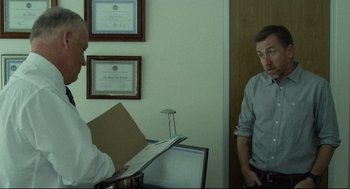 Movie still from “600 Miles” (2015), directed by Gabriel Ripstein – Two men are standing in front of each other in a room; Medium shot, Over the shoulder angle