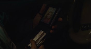 Movie still from “600 Miles” (2015), directed by Gabriel Ripstein – A person is holding an ipod in their hand; Extreme Close Up shot, Over the shoulder angle