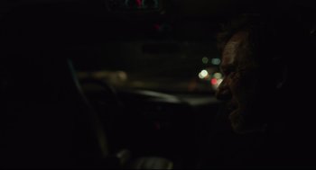 Movie still from “600 Miles” (2015), directed by Gabriel Ripstein – A man sitting in the driver's seat of a car at night; Close Up shot, Over the shoulder angle
