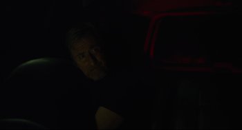 Movie still from “600 Miles” (2015), directed by Gabriel Ripstein – A man in a dark room looking at the camera; Close Up shot, Low angle