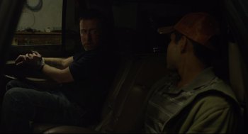 Movie still from “600 Miles” (2015), directed by Gabriel Ripstein – Two men sitting in the back seat of a car; Medium shot, Over the shoulder angle