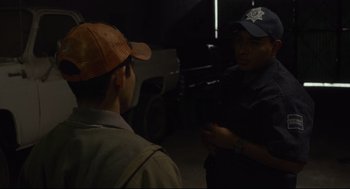 Movie still from “600 Miles” (2015), directed by Gabriel Ripstein – Two men are talking in the dark; Medium shot, Over the shoulder angle