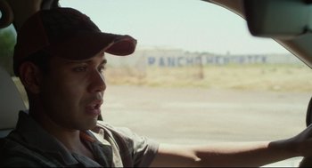 Movie still from “600 Miles” (2015), directed by Gabriel Ripstein – A man driving a car on the side of the road; Close Up shot, Over the shoulder angle