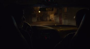 Movie still from “600 Miles” (2015), directed by Gabriel Ripstein – A man sitting in the driver's seat of a car; Medium shot, Over the shoulder angle