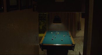 Movie still from “600 Miles” (2015), directed by Gabriel Ripstein – A green pool table with many balls on it; Wide shot, High angle