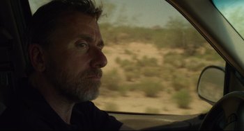 A person in a car looking out the window