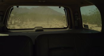 Movie still from “600 Miles” (2015), directed by Gabriel Ripstein – A view from inside of a car looking out the window; Wide shot, Low angle