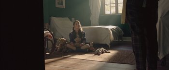 Movie still from “The Soul Collector” (2019), directed by Harold Holscher – A girl sitting on the floor with teddy bears; Wide shot, Low angle