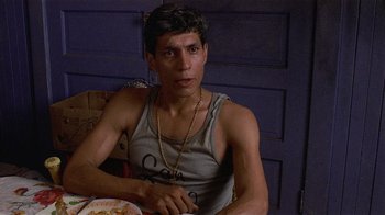 Movie still from “8 Million Ways to Die” (1986), directed by Hal Ashby – A man sitting in front of a plate of food; Close Up shot, Low angle