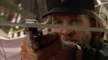 Movie still from “8 Million Ways to Die” (1986), directed by Hal Ashby – A person holding a gun; Close Up shot, Over the shoulder angle
