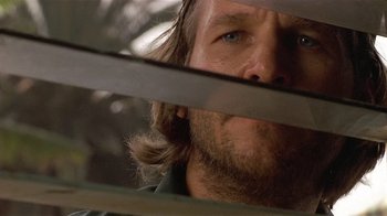 Movie still from “8 Million Ways to Die” (1986), directed by Hal Ashby – A man with long hair and a beard; Close Up shot, Low angle