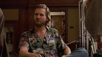 Movie still from “8 Million Ways to Die” (1986), directed by Hal Ashby – A man with long blonde hair wearing a hawaiian shirt; Medium shot, Over the shoulder angle