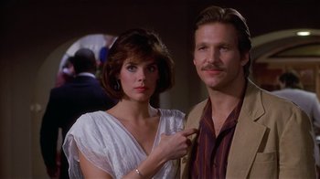 Movie still from “8 Million Ways to Die” (1986), directed by Hal Ashby – A man and a woman posing for a picture; Close Up shot, Low angle