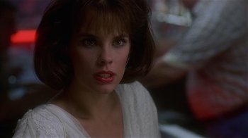 Movie still from “8 Million Ways to Die” (1986), directed by Hal Ashby – A person wearing a white shirt; Close Up shot, Over the shoulder angle