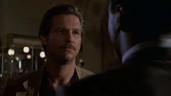 Movie still from “8 Million Ways to Die” (1986), directed by Hal Ashby – A person talking to another person; Close Up shot, Over the shoulder angle