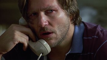 Movie still from “8 Million Ways to Die” (1986), directed by Hal Ashby – A person talking on a phone; Close Up shot, Low angle