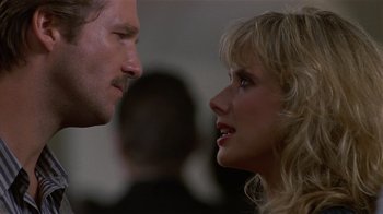Movie still from “8 Million Ways to Die” (1986), directed by Hal Ashby – A man and a woman face to face in front of a crowd; Close Up shot, Low angle