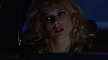 Movie still from “8 Million Ways to Die” (1986), directed by Hal Ashby – A person with blonde curly hair; Close Up shot, Low angle