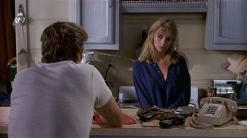 Movie still from “8 Million Ways to Die” (1986), directed by Hal Ashby – A man and a woman sitting at a counter; Medium shot, Over the shoulder angle