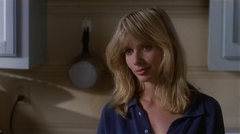 Movie still from “8 Million Ways to Die” (1986), directed by Hal Ashby – A woman in a blue shirt is smiling for the camera; Close Up shot, Low angle