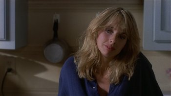 Movie still from “8 Million Ways to Die” (1986), directed by Hal Ashby – A person wearing a blue shirt; Close Up shot, Over the shoulder angle