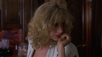 Movie still from “8 Million Ways to Die” (1986), directed by Hal Ashby – A person with curly hair; Close Up shot, Over the shoulder angle