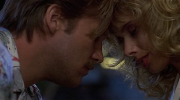 Movie still from “8 Million Ways to Die” (1986), directed by Hal Ashby – A man and a woman face to face in the dark; Close Up shot, Low angle