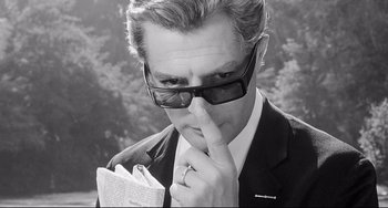 Movie still from “8½” (1963), directed by Federico Fellini – A black and white photo of a man with glasses; Close Up shot, Low angle