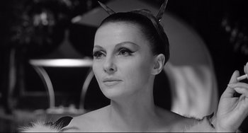 Movie still from “8½” (1963), directed by Federico Fellini – A black and white photo of a woman wearing a cat ears; Close Up shot, Low angle