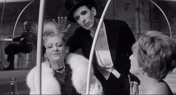 Movie still from “8½” (1963), directed by Federico Fellini – A man and a woman are posing for a picture; Close Up shot, Over the shoulder angle