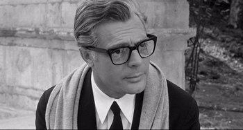Movie still from “8½” (1963), directed by Federico Fellini – Black and white photograph of a man wearing glasses; Close Up shot, Over the shoulder angle