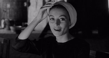 Movie still from “8½” (1963), directed by Federico Fellini – A black and white photo of a woman wearing a head scarf; Close Up shot, Low angle