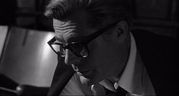 Movie still from “8½” (1963), directed by Federico Fellini – A black and white photo of a man wearing glasses; Close Up shot, Low angle