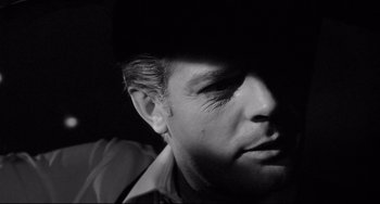 Movie still from “8½” (1963), directed by Federico Fellini – A black and white photo of a man's face; Close Up shot, Low angle