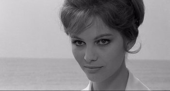 Movie still from “8½” (1963), directed by Federico Fellini – A black - and - white photo of a woman's face; Close Up shot, Over the shoulder angle