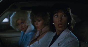 Movie still from “9 to 5” (1980), directed by Colin Higgins – A group of three women in a car looking at something; Close Up shot, Over the shoulder angle