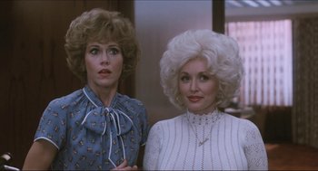 Movie still from “9 to 5” (1980), directed by Colin Higgins – A couple of women standing next to each other; Medium shot, Low angle