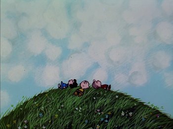 Movie still from “A Boy Named Charlie Brown” (1969), directed by Bill Melendez – A painting of a group of people sitting on a hill; Extreme Wide shot, Low angle