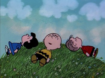 Movie still from “A Boy Named Charlie Brown” (1969), directed by Bill Melendez – A group of people laying in the grass together; Extreme Wide shot, High angle