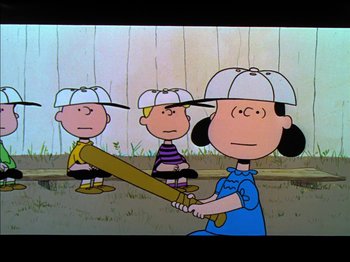 Movie still from “A Boy Named Charlie Brown” (1969), directed by Bill Melendez – A group of people standing next to each other holding baseball bats; Medium shot, Over the shoulder angle