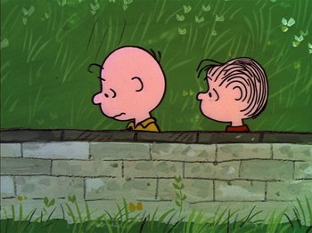 Movie still from “A Boy Named Charlie Brown” (1969), directed by Bill Melendez – A couple of people that are standing by a brick wall; Medium shot, High angle