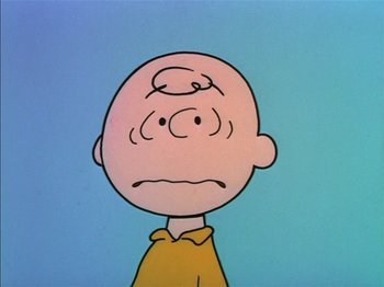 Movie still from “A Boy Named Charlie Brown” (1969), directed by Bill Melendez – A charlie brown cartoon character with a sad look on his face; Close Up shot, Low angle