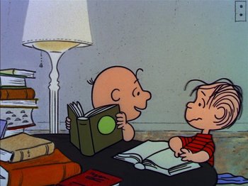 Movie still from “A Boy Named Charlie Brown” (1969), directed by Bill Melendez – A couple of people sitting at a table with a book; Medium shot, High angle